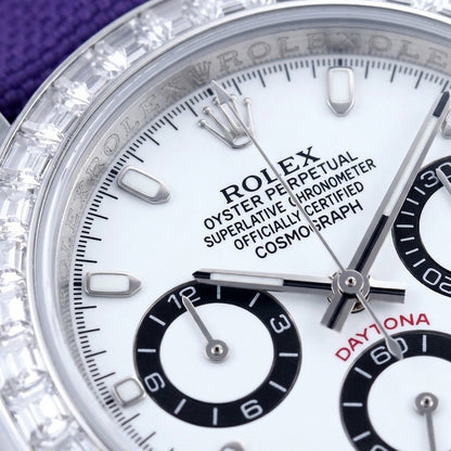 Macro of the white dial with steel baton markers and three black-ringed counters inside the ring of clear baguette-cut stones