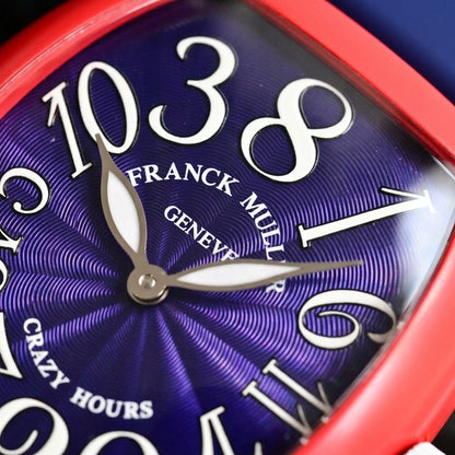 Macro of the deep blue guilloché dial with large white numerals set out of order and polished-steel leaf hands