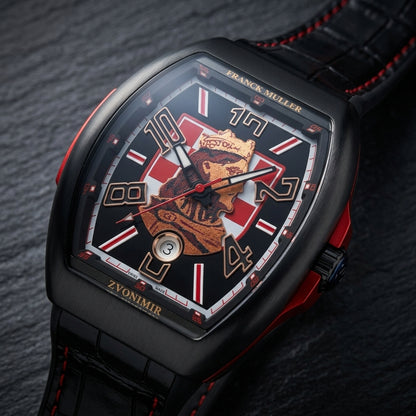 Black curved tonneau watch at a three-quarter angle on dark slate, the matte red insert in its side round the black crown