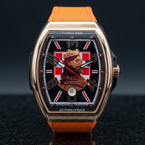 Rose gold curved tonneau watch with a black dial, a red-and-white checkerboard and a king's portrait, upright on dark slate