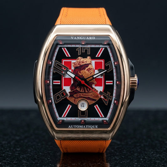Rose gold curved tonneau watch with a black dial, a red-and-white checkerboard and a king's portrait, upright on dark slate