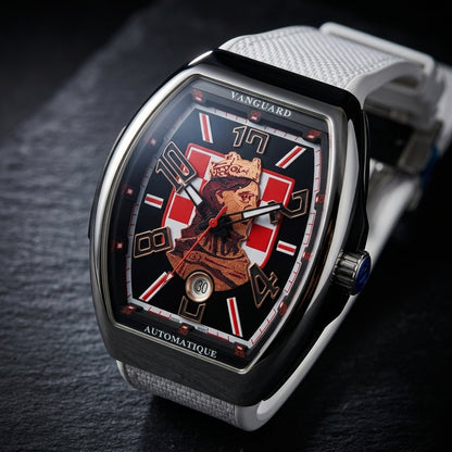 Steel curved tonneau watch at a three-quarter angle on dark slate, the blue-capped crown beside the polished steel and black case side