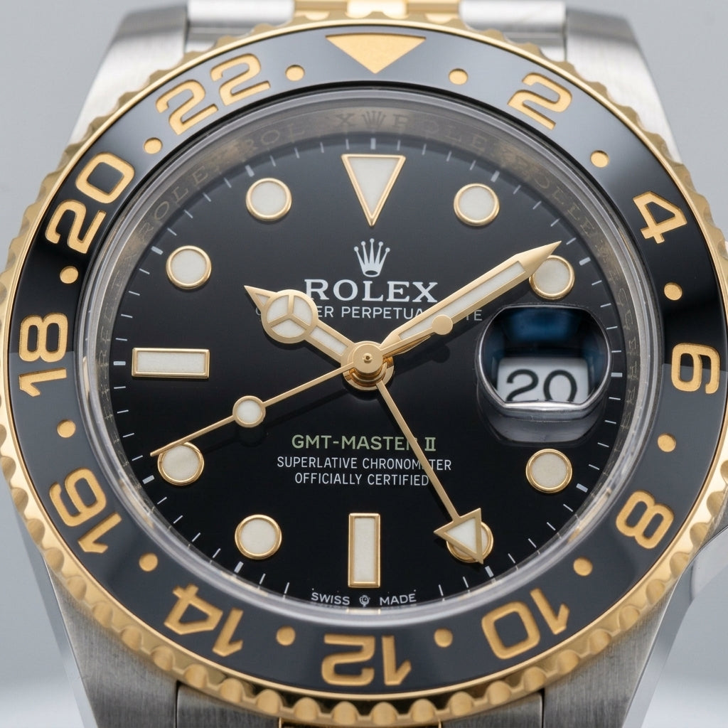 Macro of the grey and black 24-hour bezel and gold numerals