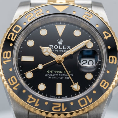 Macro of the grey and black 24-hour bezel and gold numerals