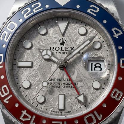 Macro of the meteorite dial pattern and blue and red bezel