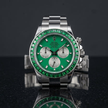 Steel chronograph with emerald green dial and green stone bezel on black granite