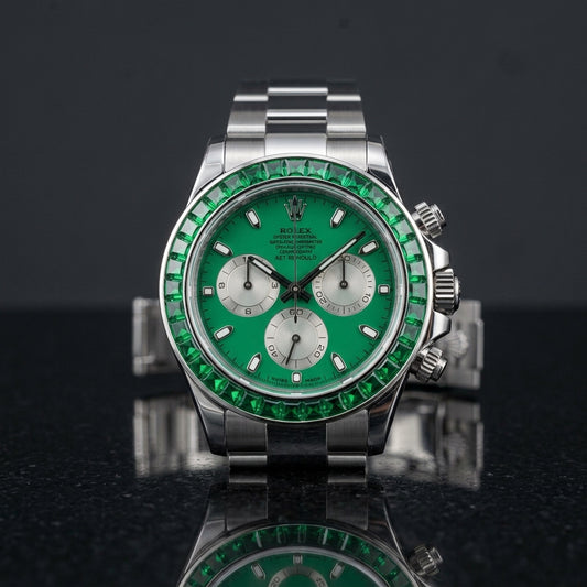 Steel chronograph with emerald green dial and green stone bezel on black granite