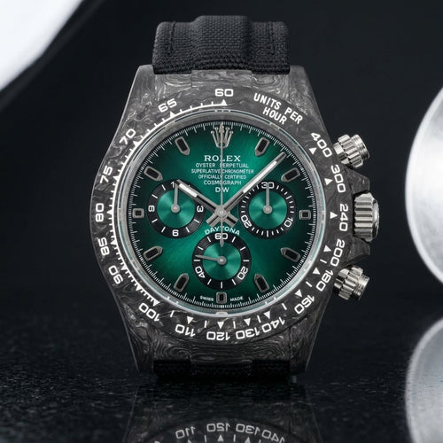 Forged-carbon chronograph with a green sun-brushed dial on pale stone
