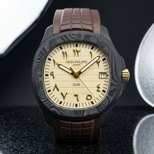 Black forged-carbon grid-dial watch with a cream dial, gold Eastern Arabic numerals and a gold crown, upright on polished black granite
