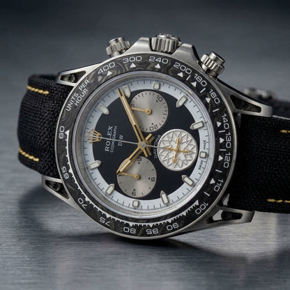 Forged carbon chronograph at a three-quarter angle on dark slate