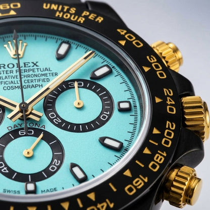 Macro of the ice-blue dial, the three black counters and the gold hands