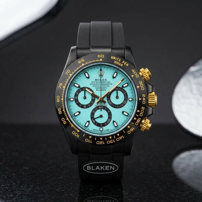 Black chronograph with an ice-blue dial worn under a navy suit cuff