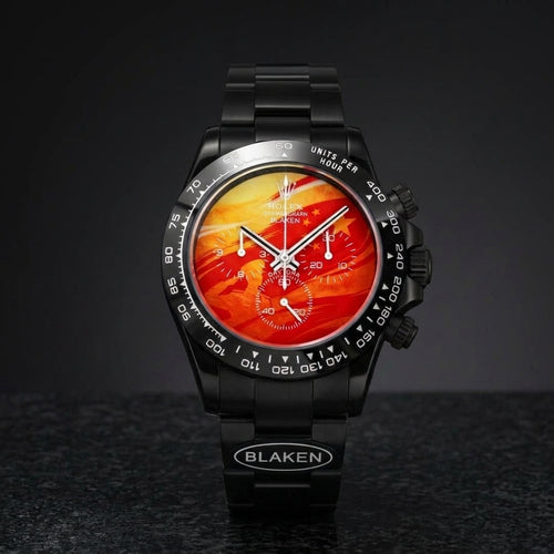 Black DLC racing chronograph with a molten orange-to-red lava dial on black granite