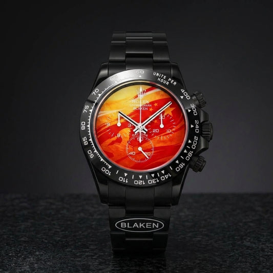 Black DLC racing chronograph with a molten orange-to-red lava dial on black granite
