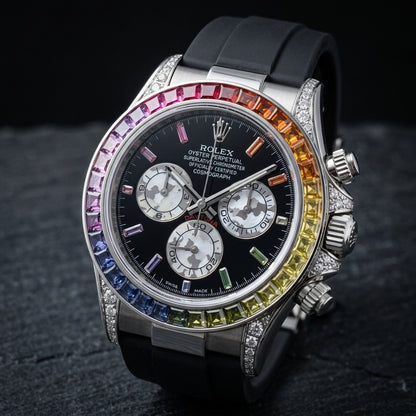 Steel rainbow chronograph at a three-quarter angle, the fluted crown and pushers between stone-set crown guards