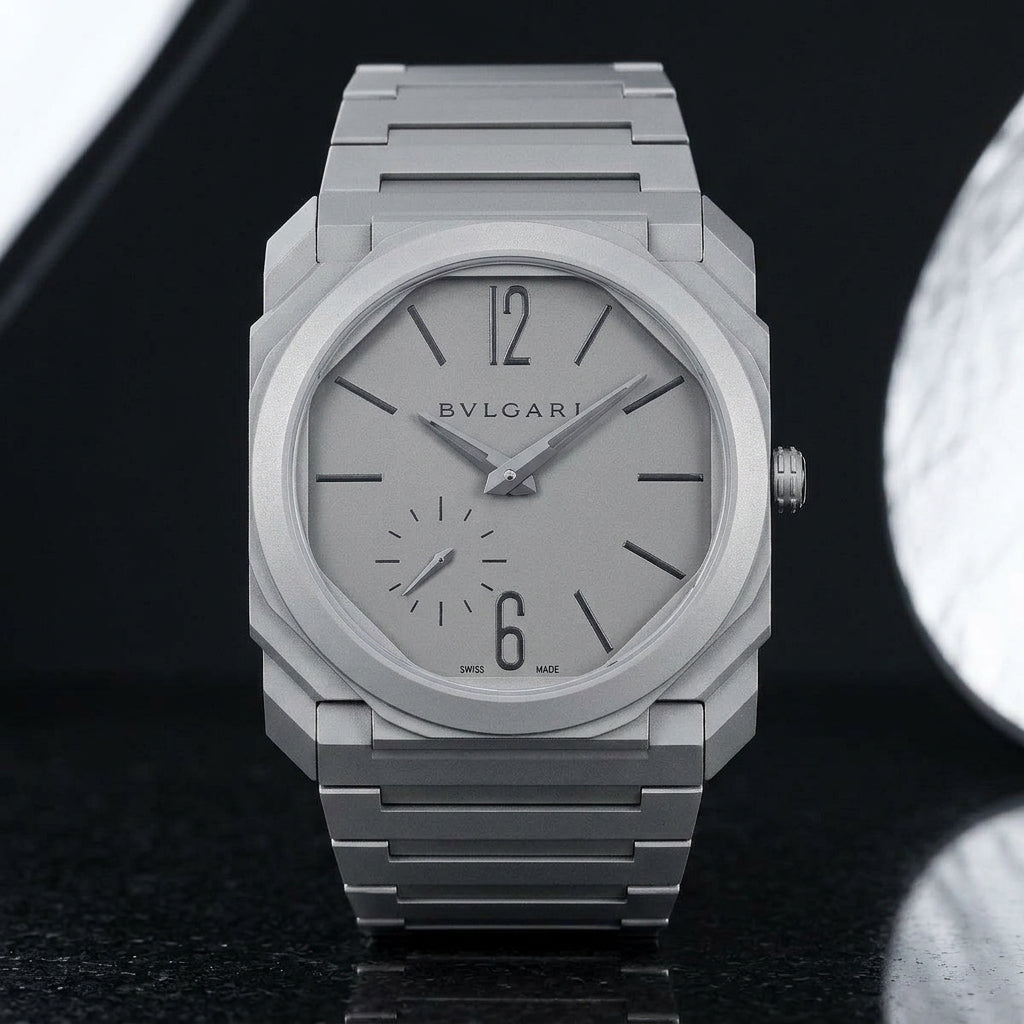 Ultra-thin sandblasted titanium octagonal watch upright on black granite