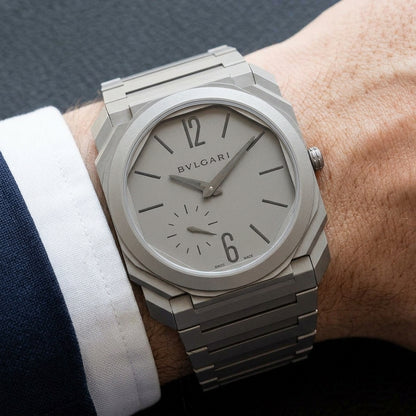 Ultra-thin titanium watch worn under a navy suit cuff
