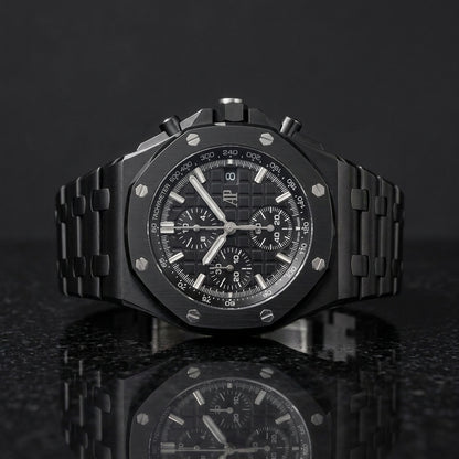 All-black ceramic octagonal chronograph watch on black granite