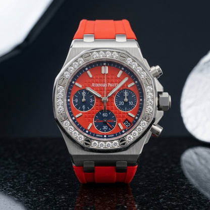 Steel octagonal chronograph with diamond bezel and red dial on black granite
