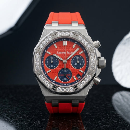 Steel octagonal chronograph with diamond bezel and red dial on black granite