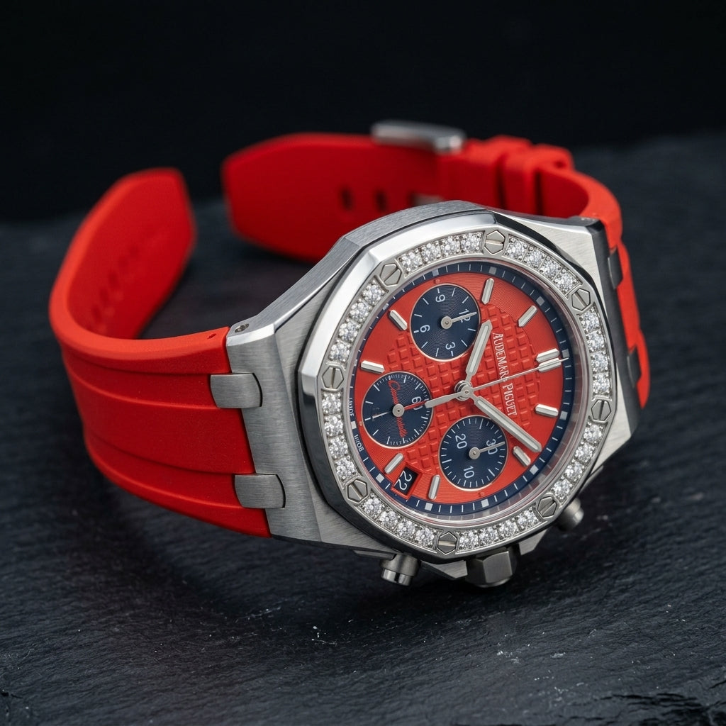 Red dial diamond bezel chronograph at a three-quarter angle on dark slate