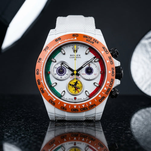 Racing Chronograph — White Ceramic, Orange Bezel — studio photograph on black granite