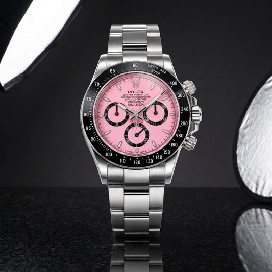 Pink-dial steel racing chronograph with a black ceramic bezel on black granite