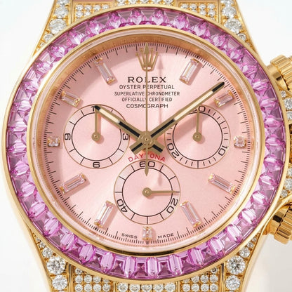 Macro of the pink dial, its pale baguette hour markers in gold settings, the pink counters and the pink stone bezel