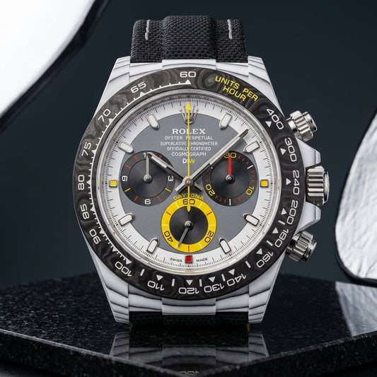 White CarboQuartz chronograph with a grey dial and yellow counter on dark stone