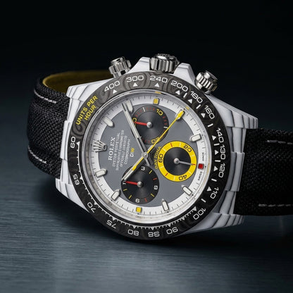 White CarboQuartz chronograph at a three-quarter angle, ribbed case flank and red-banded pusher visible
