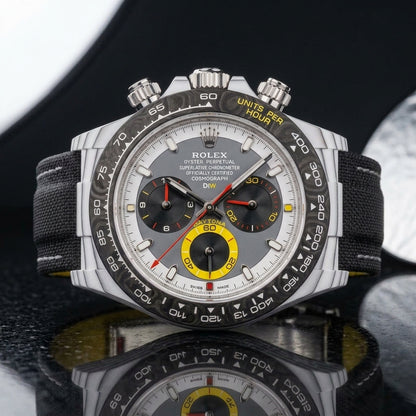 White CarboQuartz chronograph on a black woven strap, worn under a cuff