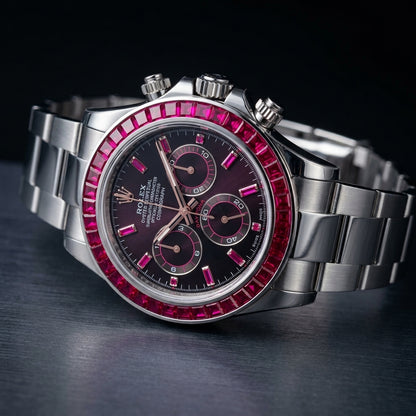 Aubergine dial steel chronograph at a three-quarter angle on dark slate