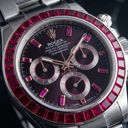 Macro of the aubergine dial, red baguette markers and rose gold hands