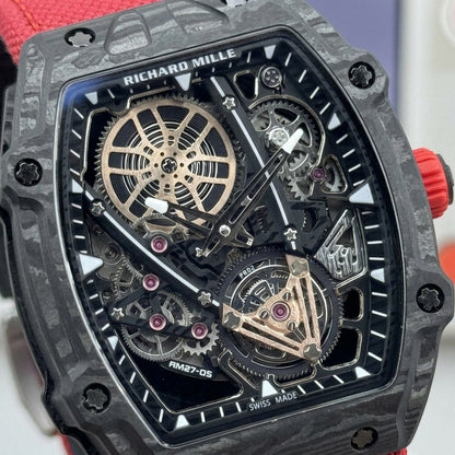 Macro of the open skeleton dial with the rose-gold spoked wheel, pink jewels and the tourbillon cage at six