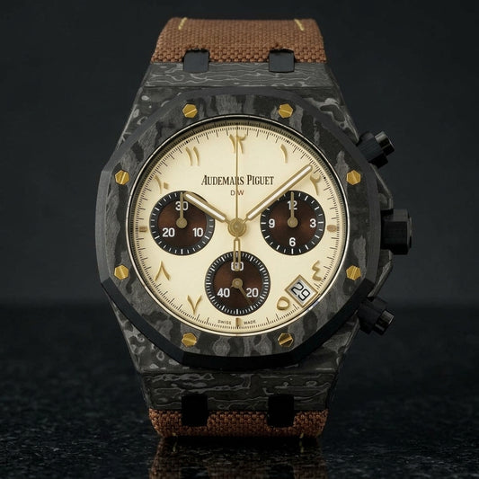 Black forged-carbon octagonal chronograph with a cream dial and gold Eastern Arabic numerals, upright on polished black granite