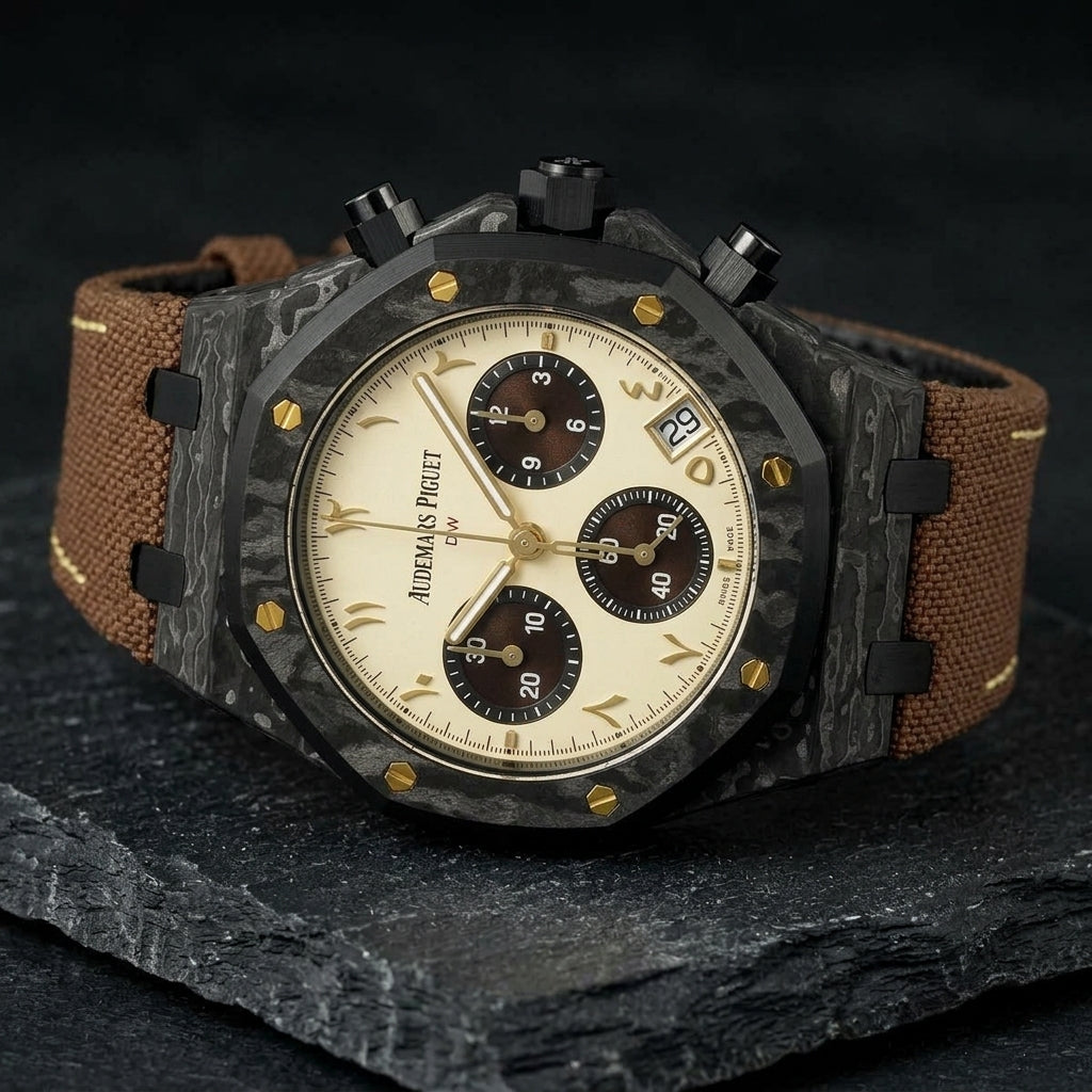 Black forged-carbon octagonal chronograph at a three-quarter angle on dark slate, whitish veining on its flank and black pushers beside the gold-screwed bezel