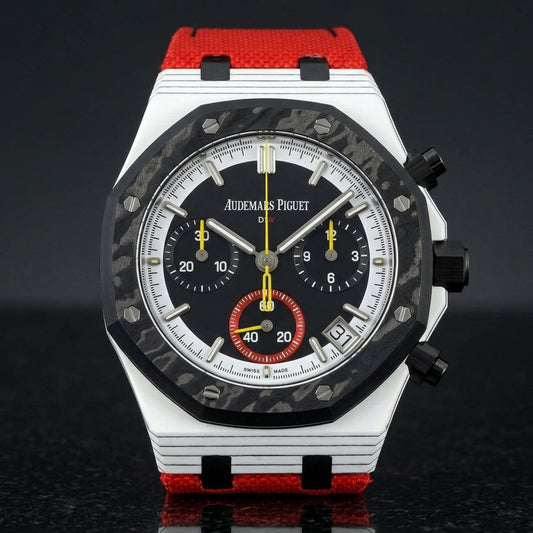 White octagonal chronograph with a black carbon bezel and a black dial, upright on polished black granite
