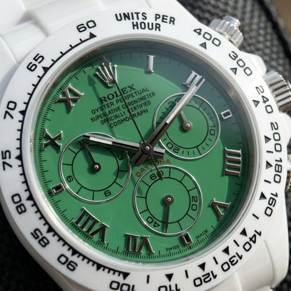 Macro of the green dial with polished steel Roman numerals and three steel-ringed green counters