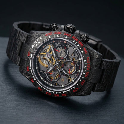 Carbon skeleton chronograph at a three-quarter angle on dark slate