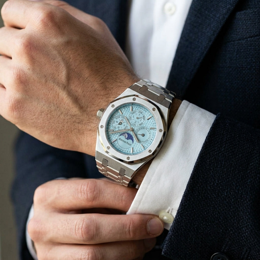 Octagonal perpetual calendar watch with an ice blue dial on the wrist as a shirt cuff is fastened