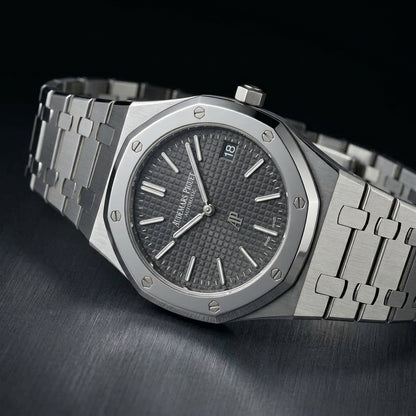 Extra-thin steel octagonal sports watch at a three-quarter angle on dark slate, showing the case profile