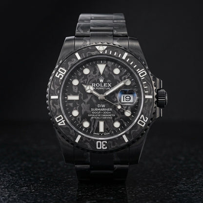 All-black forged carbon dive watch on black granite