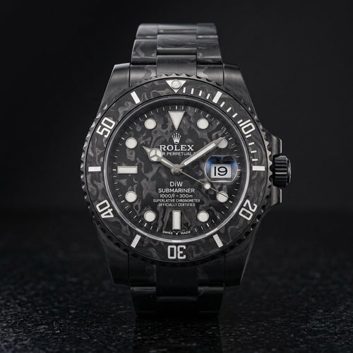 All-black forged carbon dive watch on black granite