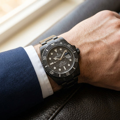 Black carbon dive watch worn under a navy suit cuff