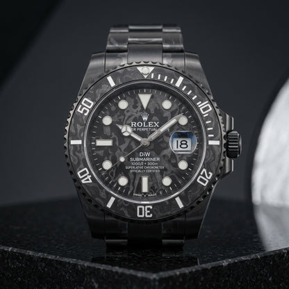 Black carbon dive watch worn under a navy suit cuff