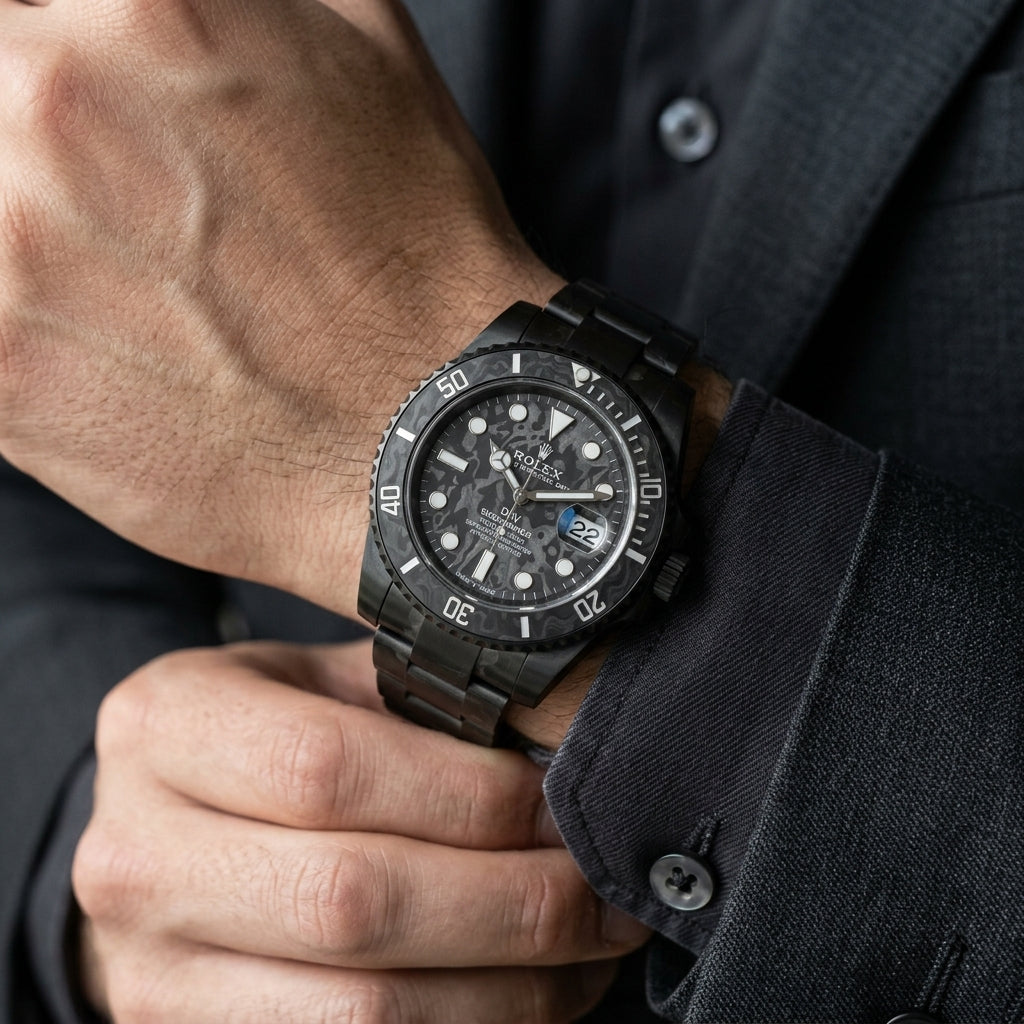 All-black forged carbon dive watch on the wrist as a shirt cuff is fastened