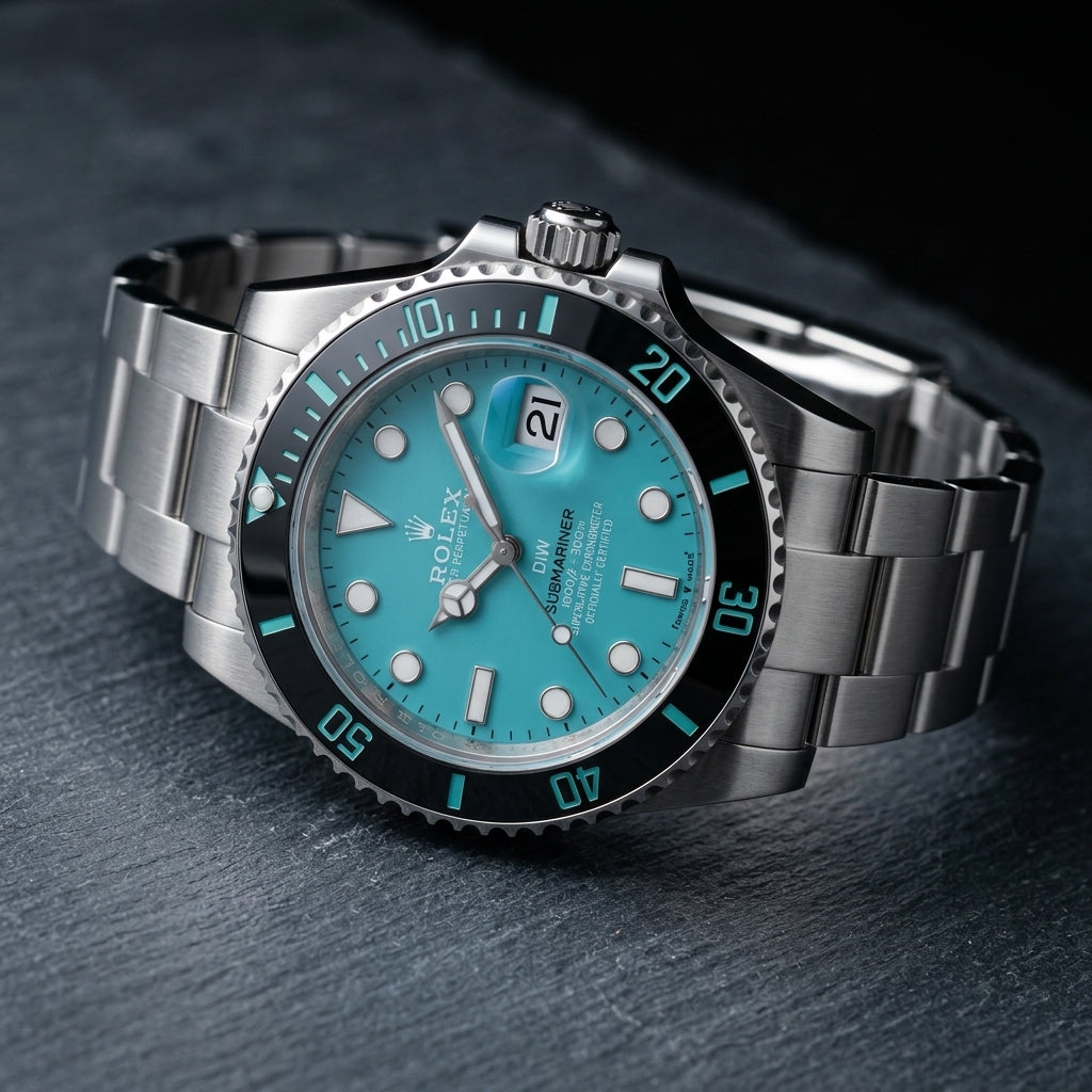 Steel dive watch at a three-quarter angle on dark slate, the screw-down crown and the coin-edge bezel