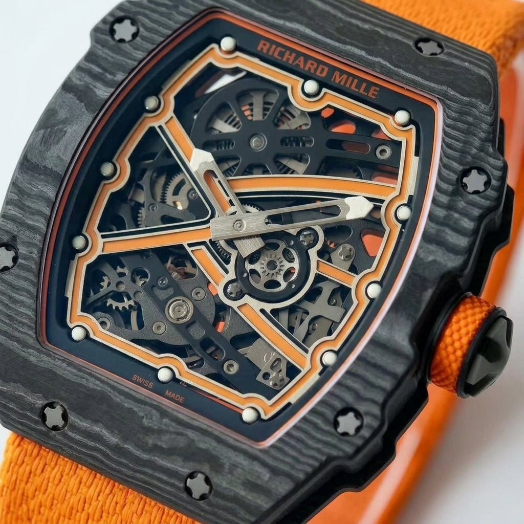 Macro of the open skeleton dial: orange frame edged in silver, orange X, twelve white hour dots and brushed silver hands