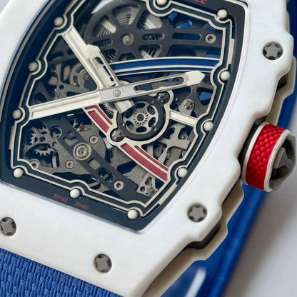 Macro of the open skeleton dial: brushed silver frame on navy, brushed silver X with a blue stripe and a red stripe, twelve white hour dots