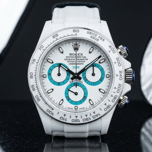 Racing Chronograph — White Ceramic, Turquoise Counters — studio photograph on black granite